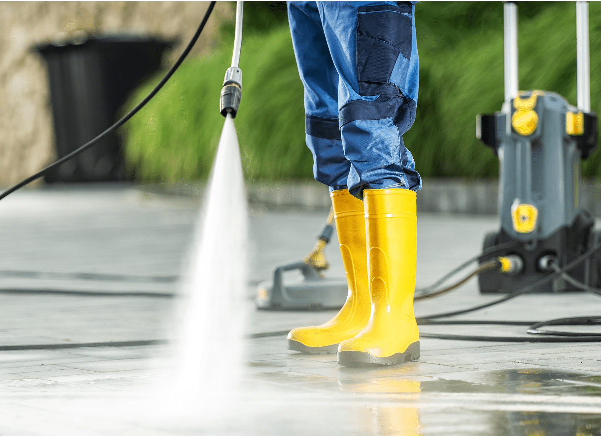 1745905168633_GettyImages-1616630956 Person pressure washing with yellow boots.