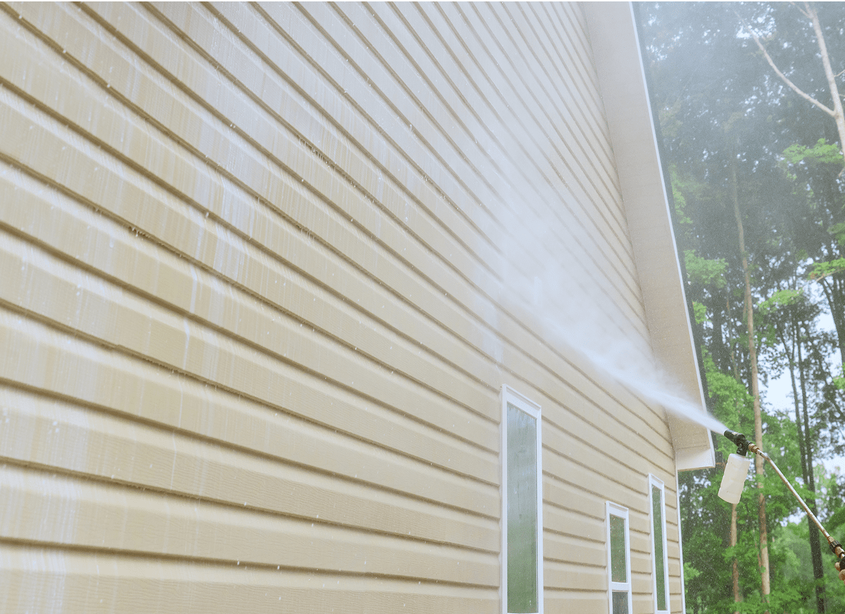 1745905230942_GettyImages-1559242236 House siding being cleaned with water spray.