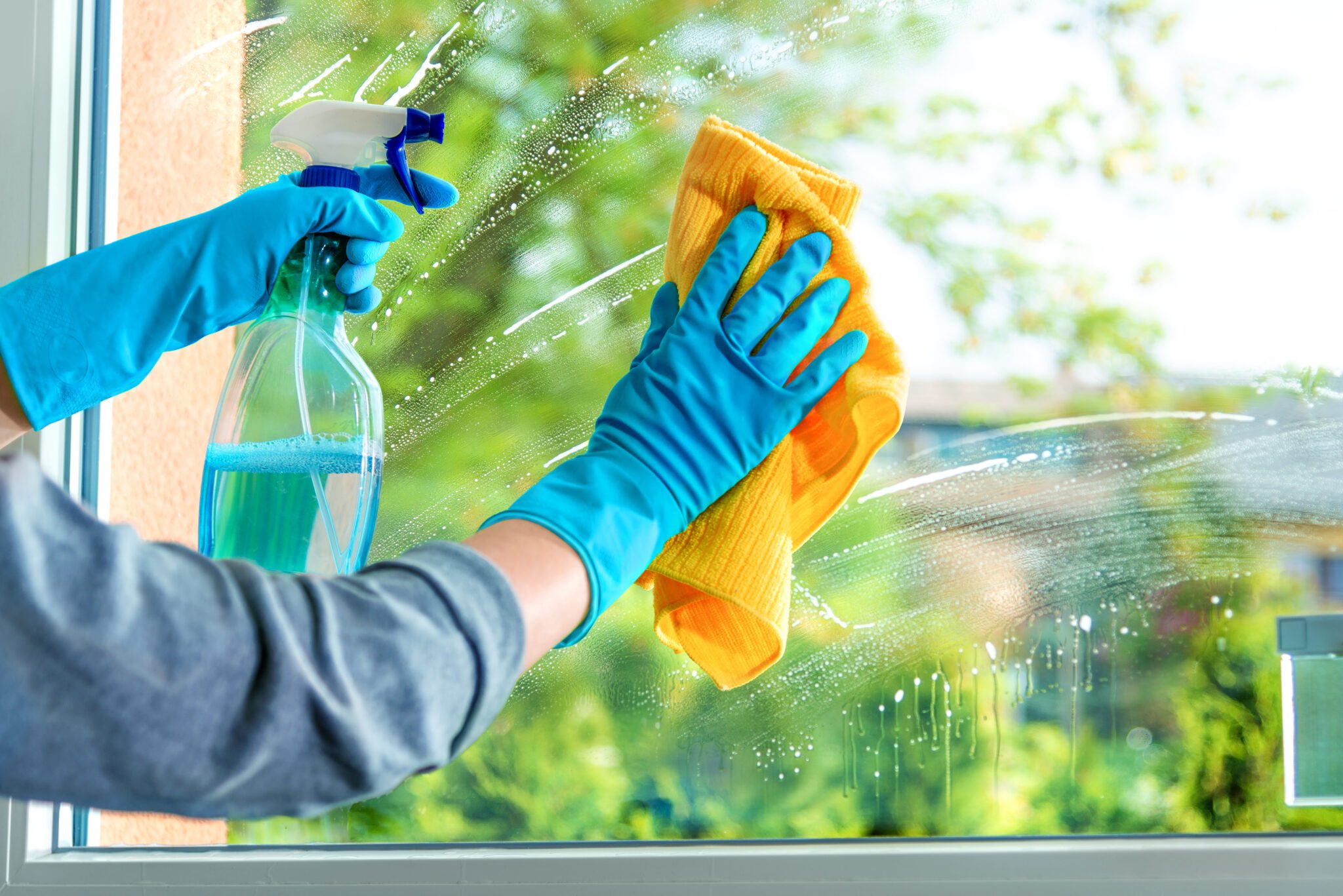 Cleaning window pane with detergent Cleaning window pane with detergent, spring cleaning concept