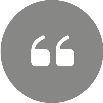 Gray circle with white quotation marks.